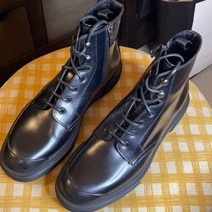 Men’s black Prada boots.